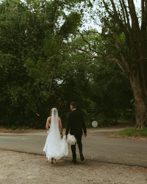 Ben and Katie walking together along a tree-lined path.